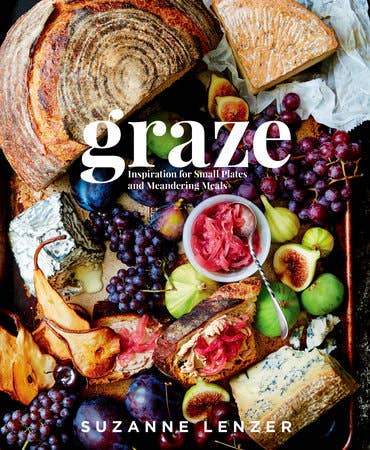 Cover of Graze by Suzanne Lenzer, showcasing a beautifully arranged grazing board with sliced bread, cheeses, grapes, figs, pears, and pickled onions for casual shared meals.