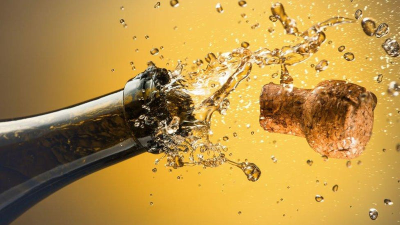 Close-up of a champagne bottle cork popping, symbolizing WINE TASTING | A SPARKLING WINE TASTING event on December 18, 2025, celebrating global sparkling wine styles.