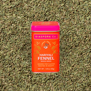 Diaspora Co. Spices - Hariyali Fennel in a small, orange container featuring vibrant green seeds, symbolizing freshness and potency, from the Sakariya family farm.