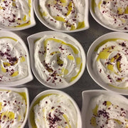 Burlap & Barrel - Cured Sumac: Ramekins with labneh topped with olive oil and cured sumac from Gaziantep, Turkey, highlighting its bright, sour flavor.