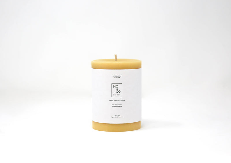 Mo&Co Home - 100% Beeswax Pillar Candle: 3x4 Inch, featuring a white label with black text, highlighting sustainable, eco-friendly design for clean burning.