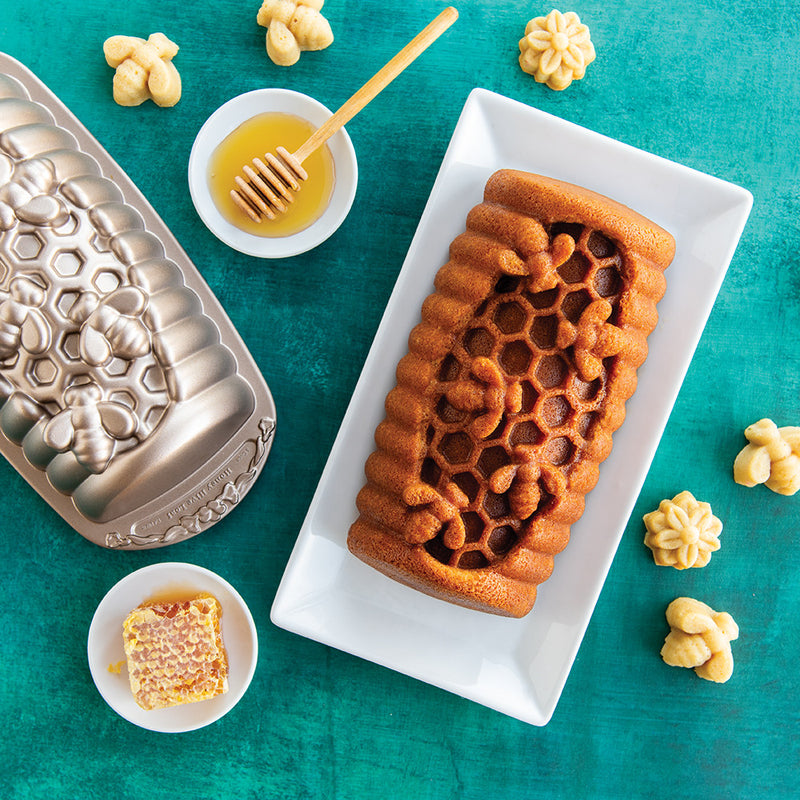 Nordic Ware | Honey Hive Loaf Pan showcasing a honeycomb-inspired design with bees, ideal for crafting unique baked goods. Perfect for Athens Cooks' curated kitchen collection.