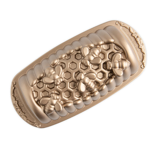 Nordic Ware | Honey Hive Loaf Pan with bee and honeycomb design, perfect for baking detailed loaves, available at Athens Cooks kitchen store.