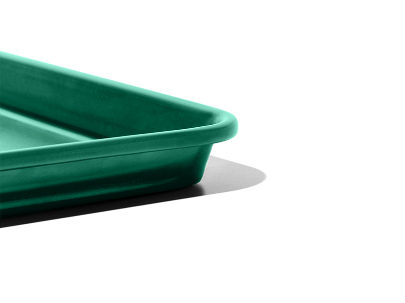 Great Jones | Little Sheet - Pepper, a compact nonstick baking tray, ideal for small ovens and personal servings, showcased in a close-up image.