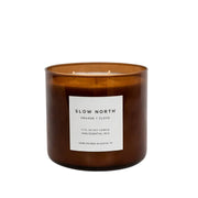 Slow North - Orange + Clove Signature 3-Wick Candle in amber glass jar, hand-poured, features warm citrus and spice aroma, ideal for cozy, inviting spaces.