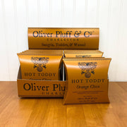 Oliver Pluff & Company - Orange Clove Hot Toddy kit displayed on a countertop, showcasing its 1.5oz spice package for brewing a soothing winter drink.