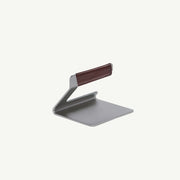 Sleek Z-shaped aluminum laptop stand with brown leather grip, designed for ergonomic viewing. Part of Athens Cooks' curated collection of kitchen and lifestyle accessories.
