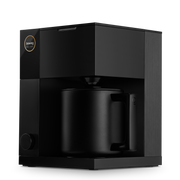 FELLOW - Aiden Precision Coffee Maker: Matte Black, displayed with a matching mug, exemplifies precise brewing for optimal coffee experience. Available for pre-order at Athens Cooks.