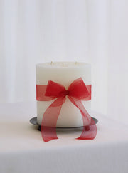 Mo&Co Home - 200h Burn | GRAND Beeswax Pillar Candle | Natural White with red ribbon on metal plate, ideal for gifting and enhancing winter evenings.