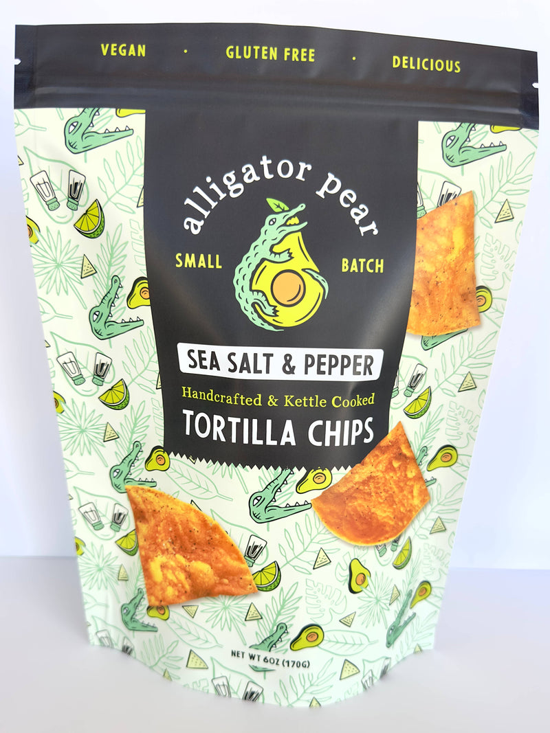 Alligator Pear Foods - Sea Salt & Pepper tortilla chips, 6oz bag featuring a cartoon crocodile and labeled as gluten-free, perfect for pairing with dips.