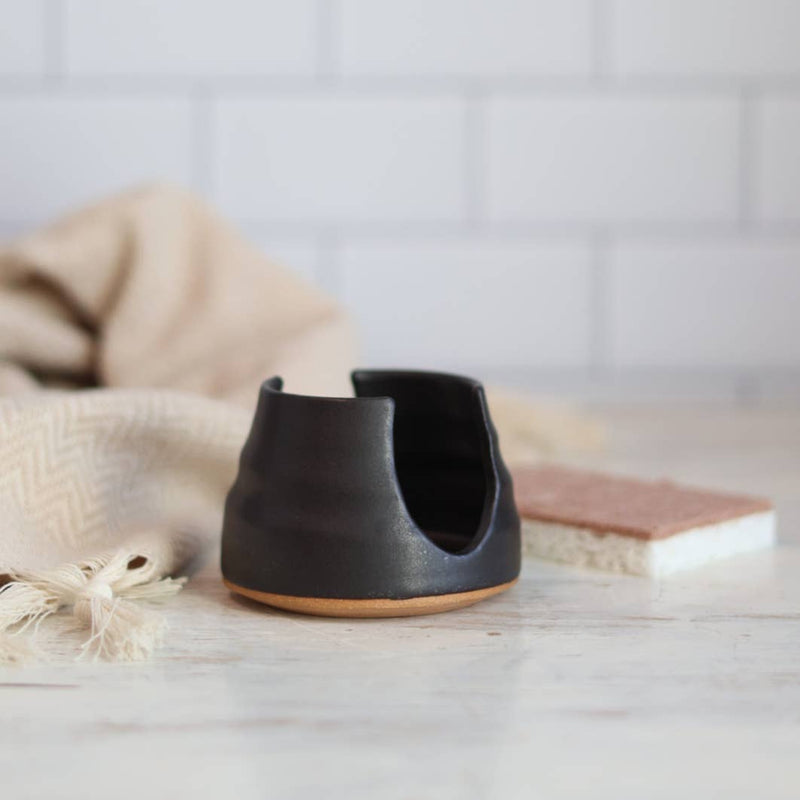 Gravesco Pottery - Sponge Holder in Black on countertop, with tea towel and sponge nearby, offers modern kitchen style and functional storage with a handmade touch.