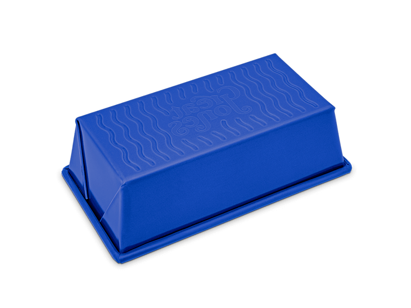 Great Jones | Breadwinner - Raspberry loaf pan with a wavy, corrugated bottom, designed for easy release and durability.