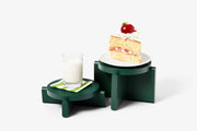Areaware - Pedestal Set - Green displaying a slice of cake with a strawberry and a glass of milk on solid beechwood pedestals.