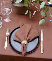MagicLinen - Set of 2 linen napkins displayed on a stylishly set table with silverware and a wine glass. Ideal for enhancing table decor.