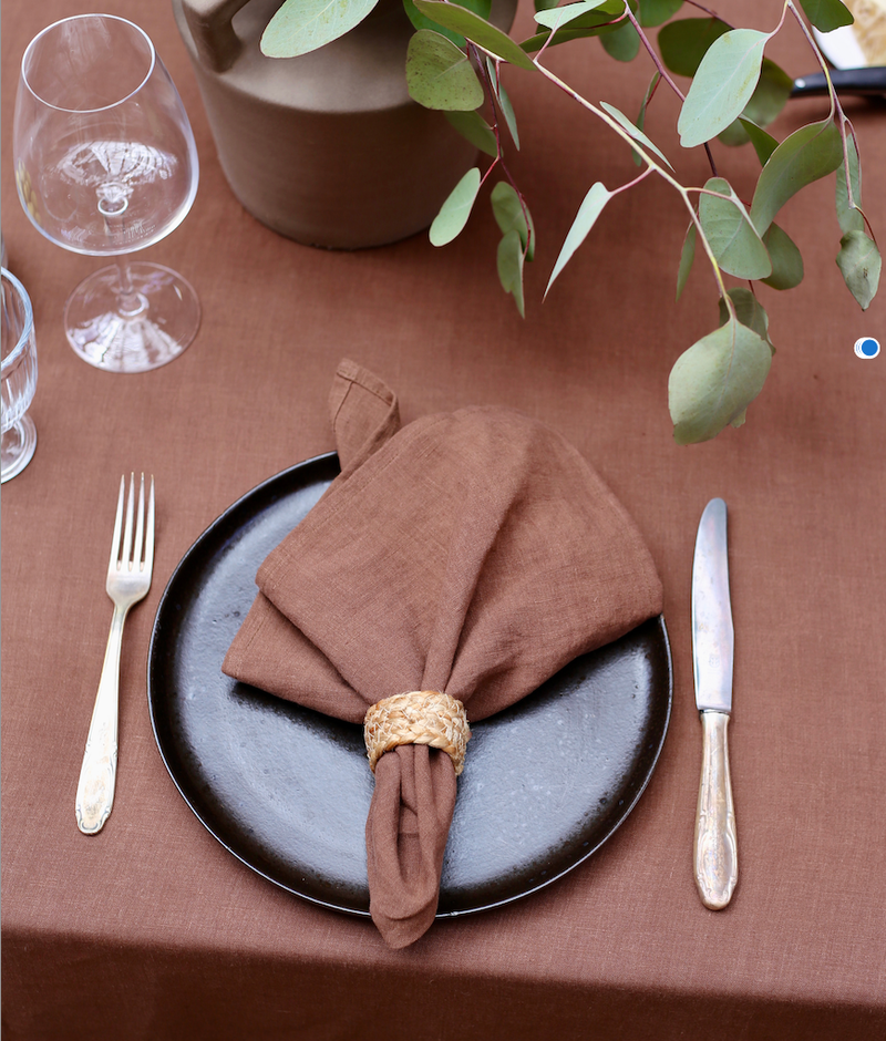 Set of 2 MagicLinen napkins, elegantly folded on a plate, ideal for enhancing table decor with their premium linen texture.