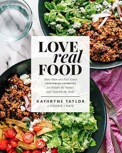Cover of Love Real Food cookbook by Kathryne Taylor, featuring vibrant vegetarian bowls with grains, cheese, and veggies, embodying wholesome, plant-based cooking.
