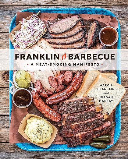 Cover of Franklin Barbecue: A Meat-Smoking Manifesto featuring Texas-style barbecue with brisket, sausages, ribs, bread, sauces, pickles, potato salad, and coleslaw.