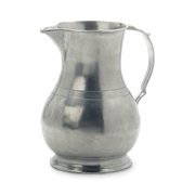 Match | Luciano Pitcher: A silver-gray metal jug with a handle and tapered spout, featuring a classic, bulbous form on a pedestal base, ideal for kitchen use.