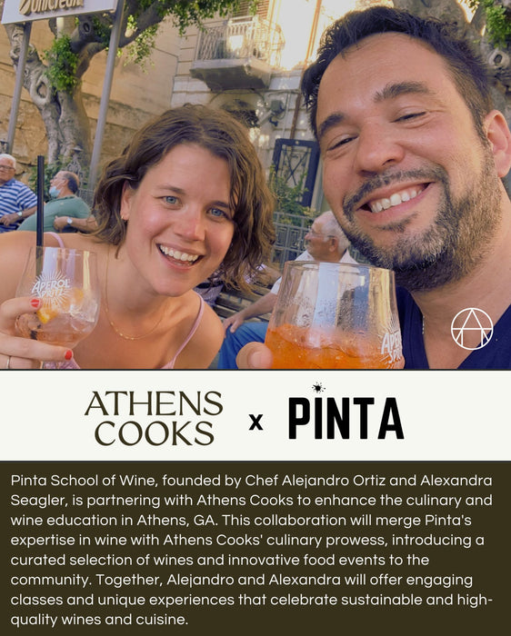 A man and a woman, smiling and holding glasses of orange drinks, pose for a photo outdoors by a stone wall. Beneath them is text announcing the WINE TASTING | Athens Cooks x Pinta School Wine: THE MYTHIC WINES OF BURGUNDY: An Introduction on Tuesday, October 22nd, from 6:30pm to 8:00pm. This event highlights the exciting partnership between Athens Cooks and Pinta School of Wine to bring exquisite Burgundy wine-tasting sessions to their upcoming culinary events.