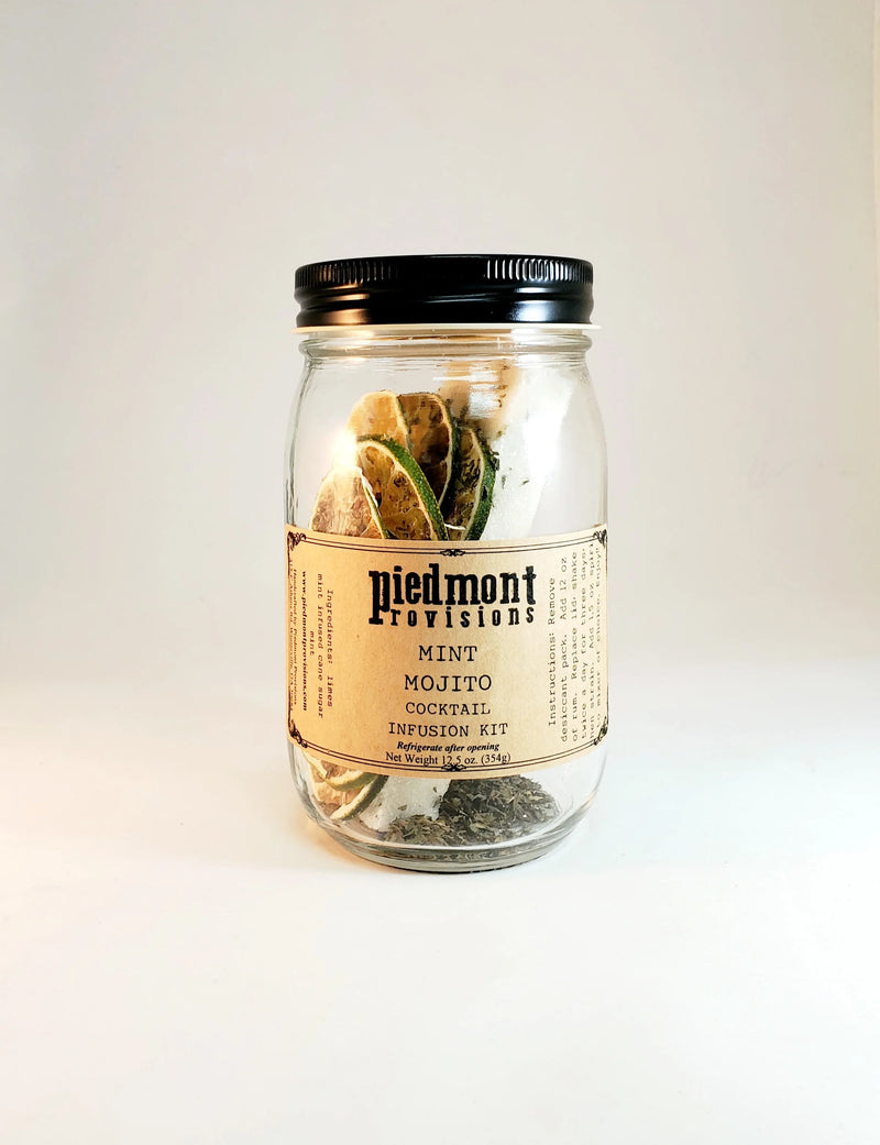Piedmont Provisions | Mint Mojito Cocktail Infusion Kit in a clear jar with layers of sugar, dried mint, and citrus slices.