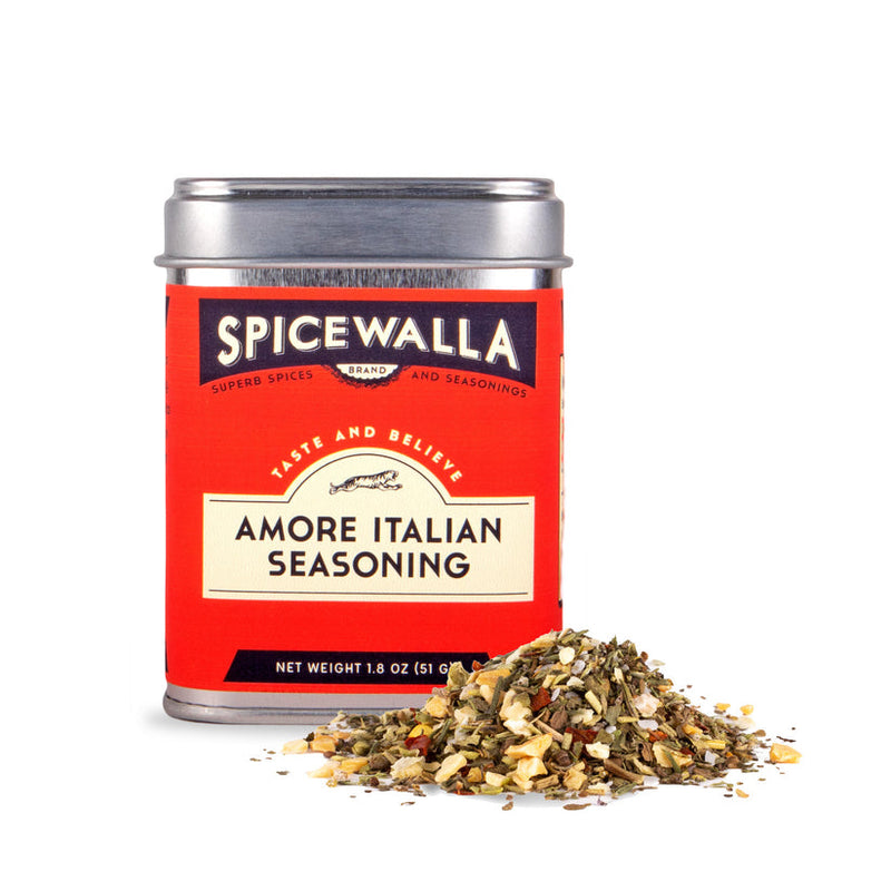Spicewalla | Amore Italian Seasoning tin with herb blend spilling out, showcasing garlic, basil, and crushed red pepper. Ideal for enhancing Italian dishes like pastas or sauces.