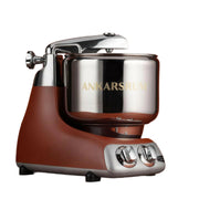 Ankarsrum | Stand Mixers: Retro-styled mixer with stainless-steel bowl, speed/timer dials, designed for heavy-duty baking tasks. Ideal for home chefs and baking enthusiasts.