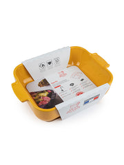 Peugeot | Appolia Rectangular Baking Dish, Saffron Yellow, in retail packaging, highlights its oven and dishwasher safety, 10-year guarantee, and sample photo of roasted vegetables.