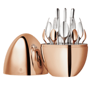 Christofle | MOOD Precious 24 Pieces: Polished egg-shaped case revealing organized cutlery set, featuring silver plate and rose gold finish, elegantly stored and displayed.