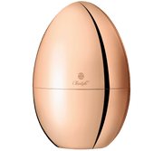 Christofle | MOOD Precious 24 Pieces: A rose-gold, egg-shaped metal box by Christofle, housing a 24-piece flatware set with elegant organization inside.