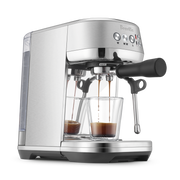 Breville | Bambino Plus espresso machine pulling shots into glass cups, showcasing its dual portafilter and steam wand, perfect for precise home brewing.