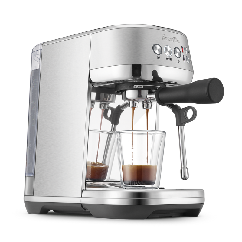 Breville | Bambino Plus espresso machine pulling shots into glass cups, showcasing its dual portafilter and steam wand, perfect for precise home brewing.