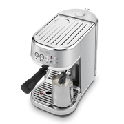 Breville | Bambino Plus espresso machine with portafilter and steam wand frothing milk, showcasing professional-grade features for home baristas, available at Athens Cooks.