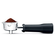 Breville | Bambino Plus portafilter loaded with freshly ground coffee, showcasing precise dosing for optimal espresso extraction at Athens Cooks kitchen store.