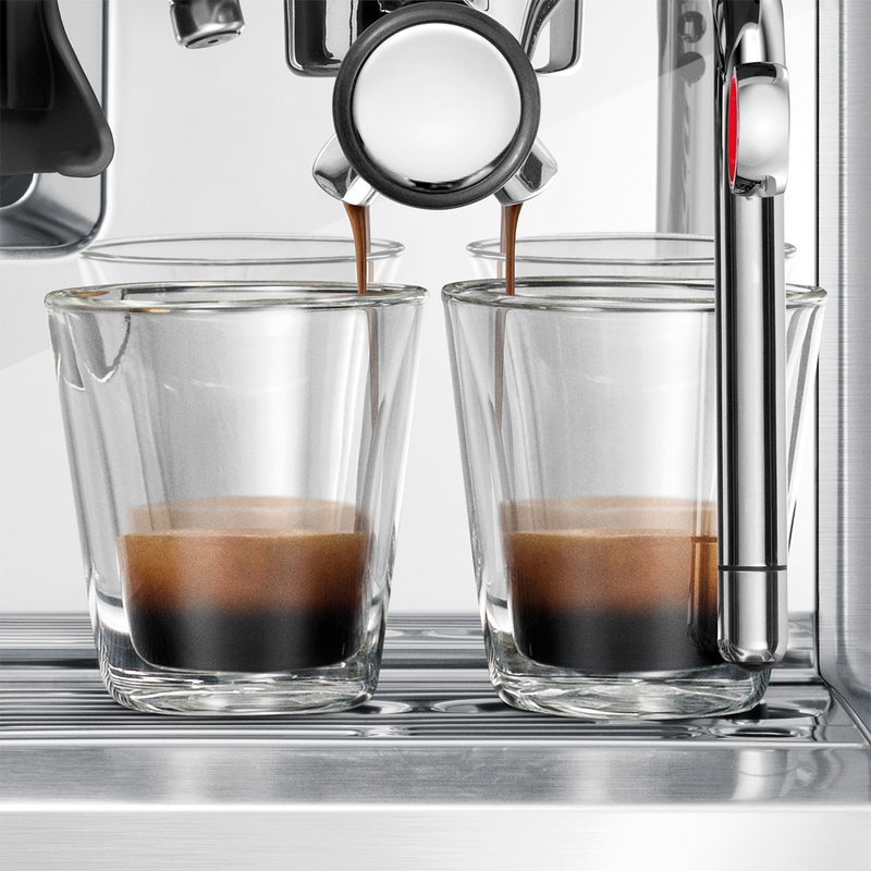 Breville | Barista Touch espresso machine pulling two shots with rich crema into glass cups, showcasing precise brewing and professional-grade features.