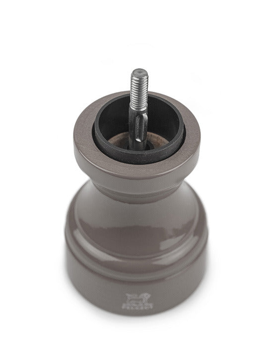 Peugeot | Bistro Pepper Mill, Smoked Grey, showcasing its exposed ceramic grinding mechanism and adjustable top button for customizing pepper coarseness.