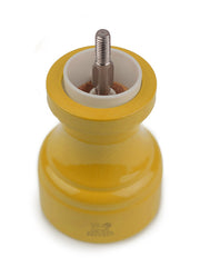 Peugeot | Bistro Pepper Mill, Saffron: A timeless, saffron yellow wooden pepper mill with a classic design, embodying elegance and functionality for your kitchen collection.
