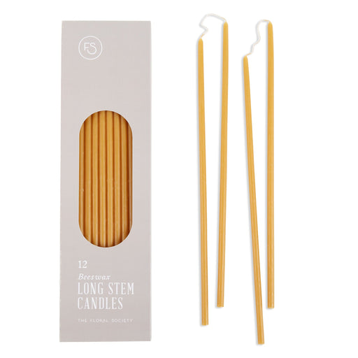 The Floral Society | Long Stem Beeswax Candles, Ochre: Boxed set of 12 golden taper candles with four displayed, ideal for elegant dining and intimate settings.