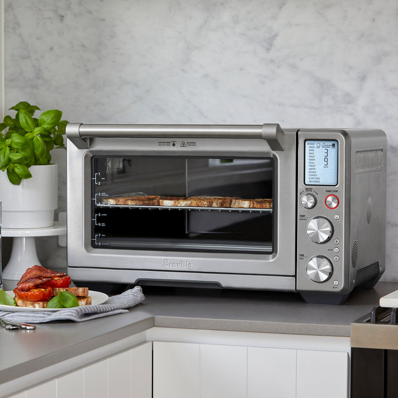 Breville | Smart Oven Air Fryer Pro on countertop with toasted bread, showcasing its air frying capability, perfect for culinary enthusiasts at Athens Cooks.
