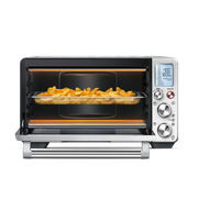 Breville | Smart Oven Air Fryer Pro with open door showing fries in basket, heating elements glowing, set to 400°F for 18 minutes.
