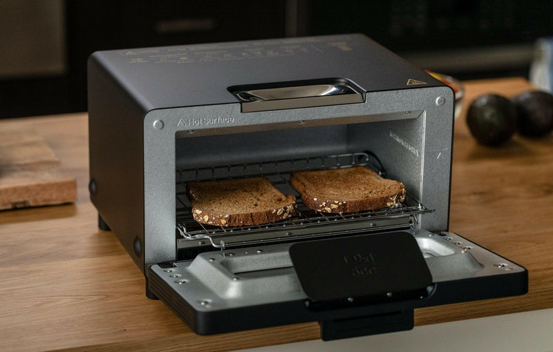 BALMUDA | The Toaster - White, showcasing slices of bread inside, illustrates its steam technology and precise heat control for perfect toasting results.