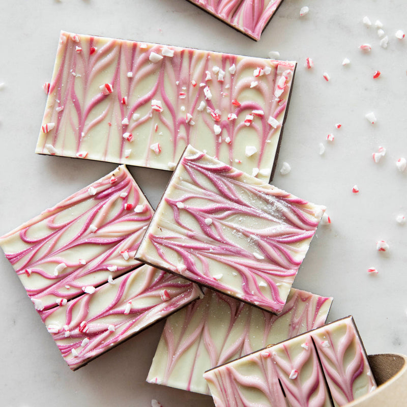 Hester & Cook | Sparkle Bark - 8 oz. features dark chocolate topped with pink-swirled white chocolate and sprinkled with peppermint candy, perfect for gourmet kitchen enthusiasts.