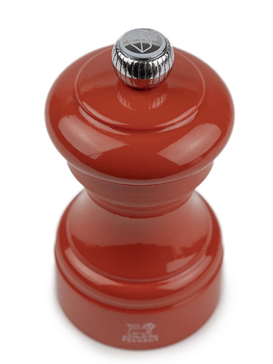 Peugeot | Bistro Salt Mill, Terracotta: A classic hand-held pepper grinder with a glossy red finish, adjustable knob, and durable steel mechanism, embodying French café charm.