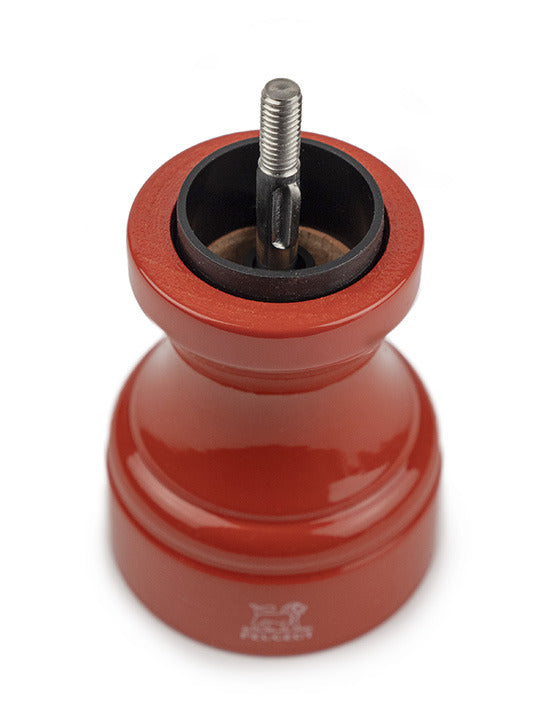 Peugeot | Bistro Pepper Mill, Terracotta, disassembled, showing red grinder body with exposed central mechanism, designed for durability and gourmet use, made from sustainable French wood.