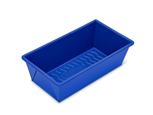 Great Jones | Breadwinner - Raspberry: A close-up of a blue rectangular baking dish with a wavy, corrugated bottom and nonstick ceramic coating for easy release.