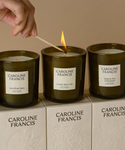 Caroline Francis | A Good Man's Life candle being lit, showcasing a hand-poured coconut soy wax jar with a white label.