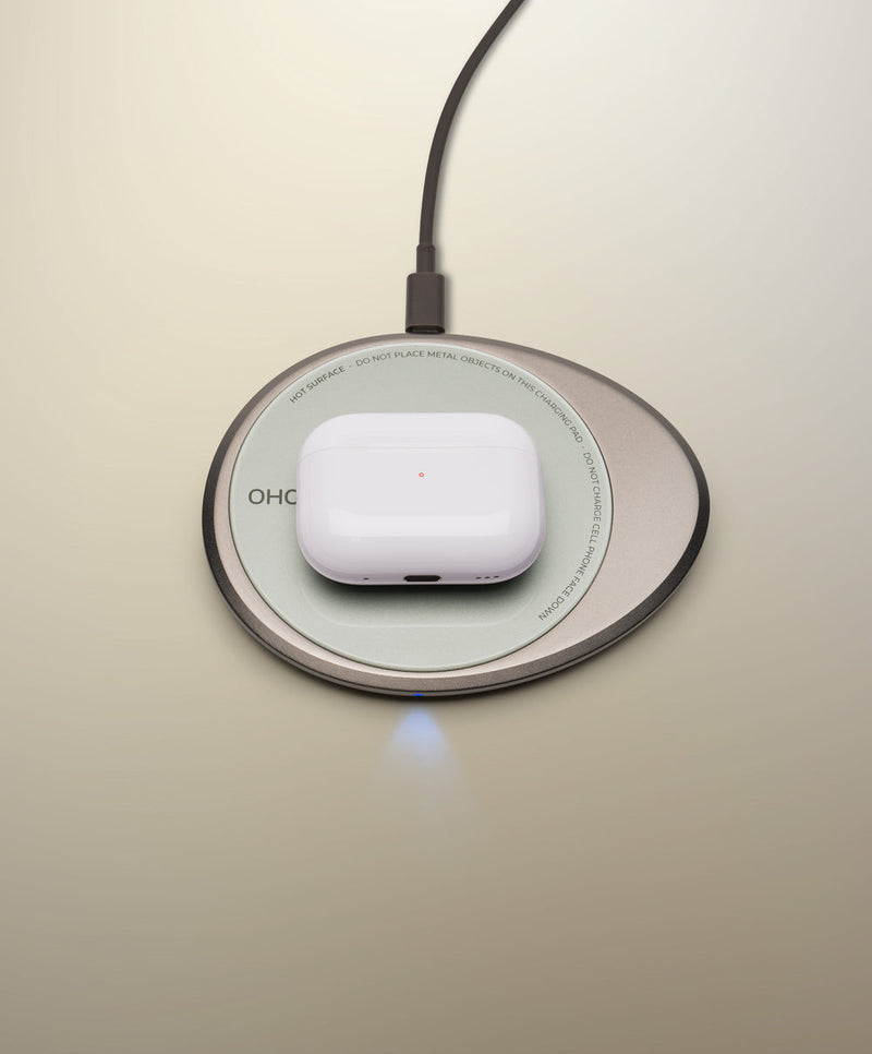 OHOM | Ui 3 Self-heating Mug Set: Moonmist Blue, shown with wireless-charging pad powering a glossy earbud case, highlighting its dual functionality for practical kitchen use.