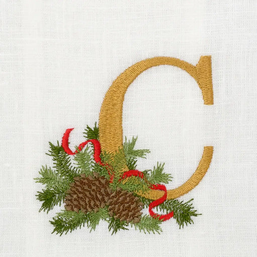 Arte Italica & Crown Linen Designs Winter Pine Monogram Towel, C, White features a gold C with pine and ribbon detail, enhancing kitchen elegance.