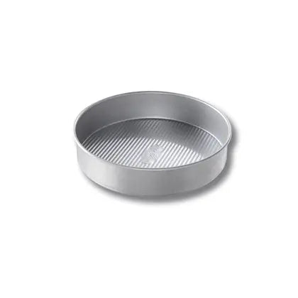 USA Pan | Cake Pans - 10 in Round, featuring FDA-approved Americoat® nonstick coating and ridged texture for efficient baking and easy cleanup, ideal for all bakers.