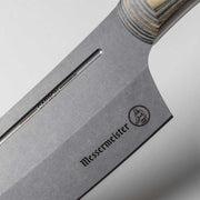 Messermeister | Bunka 8 Chef's Knife close-up showing the etched “CARBON” label, logo, and layered handle, highlighting its precision-crafted carbon-steel blade and ergonomic design.