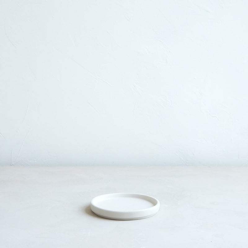 The Floral Society | Daily Plate, Sand: A minimalist white ceramic dish, ideal for holding candles or as a versatile accessory for any kitchen or dining space.